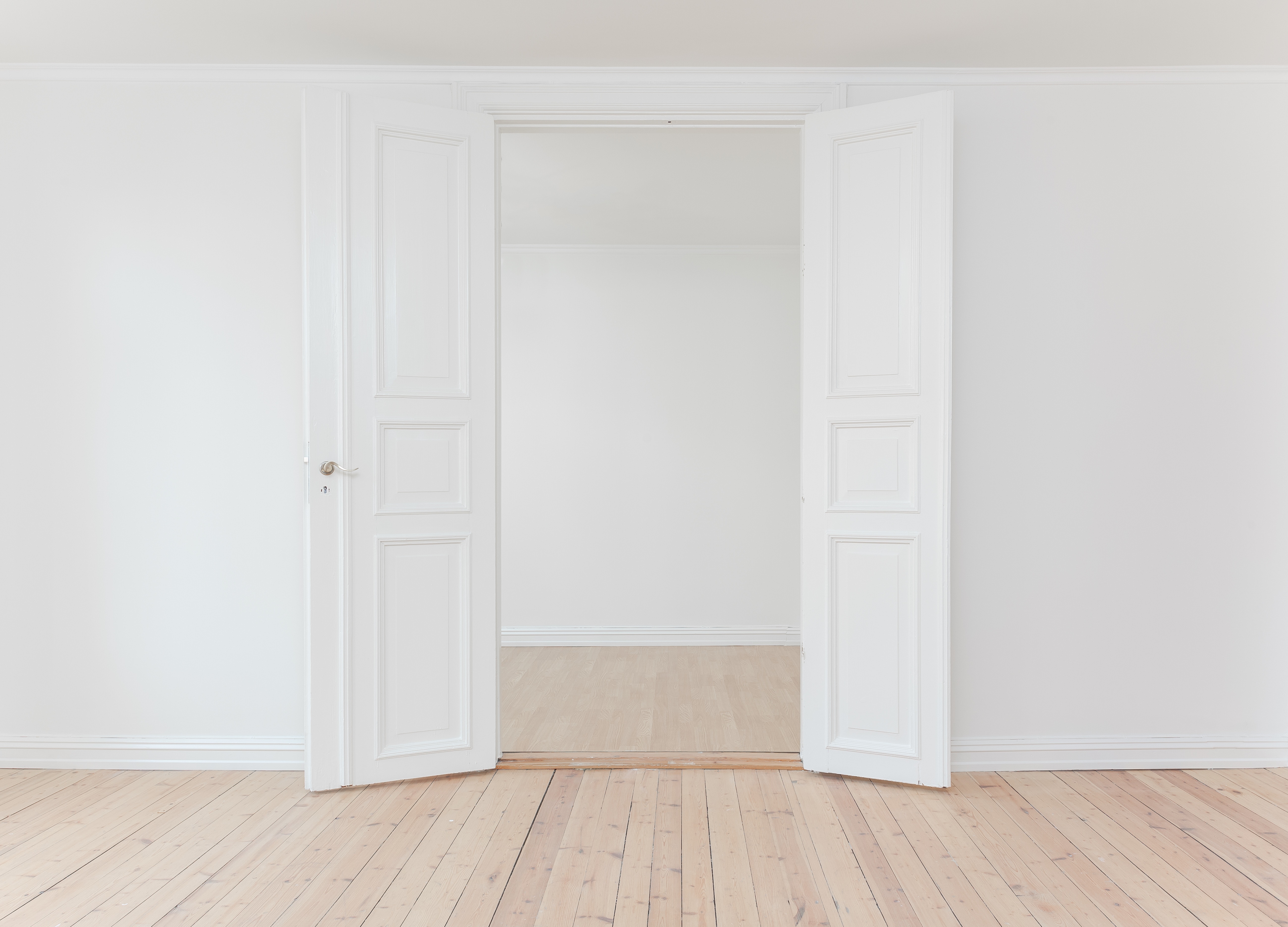 a white door opened to an empty room